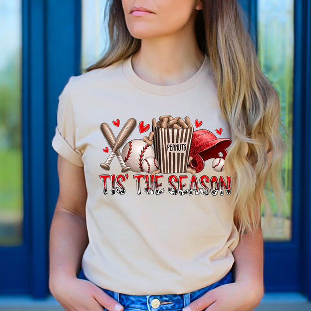 Person wearing a t-shirt with sports-themed graphics and text.