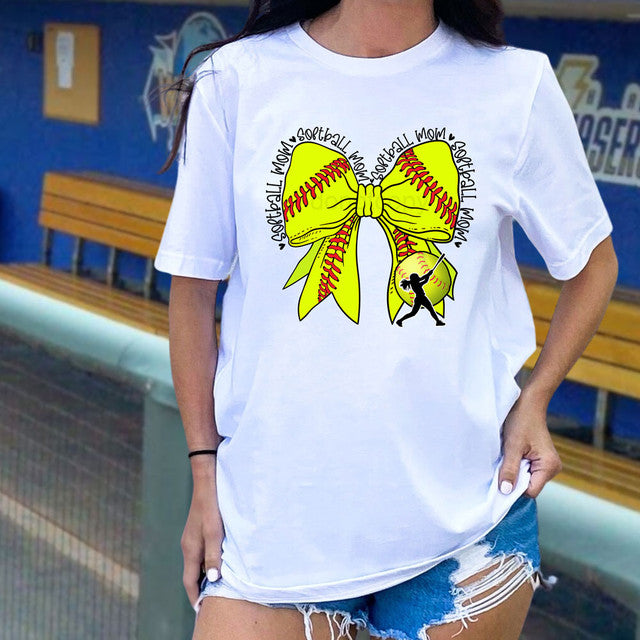 Person wearing a white t-shirt with a yellow softball bow design.