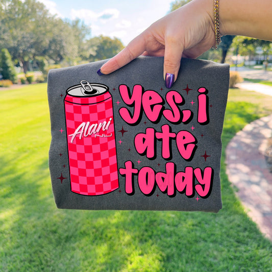 Person holding a gray bag with a pink can and text design outdoors