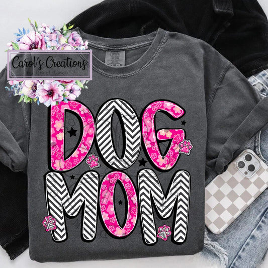 Gray sweatshirt with 'DOG MOM' text in pink and black patterns, surrounded by floral decorations and denim jeans.