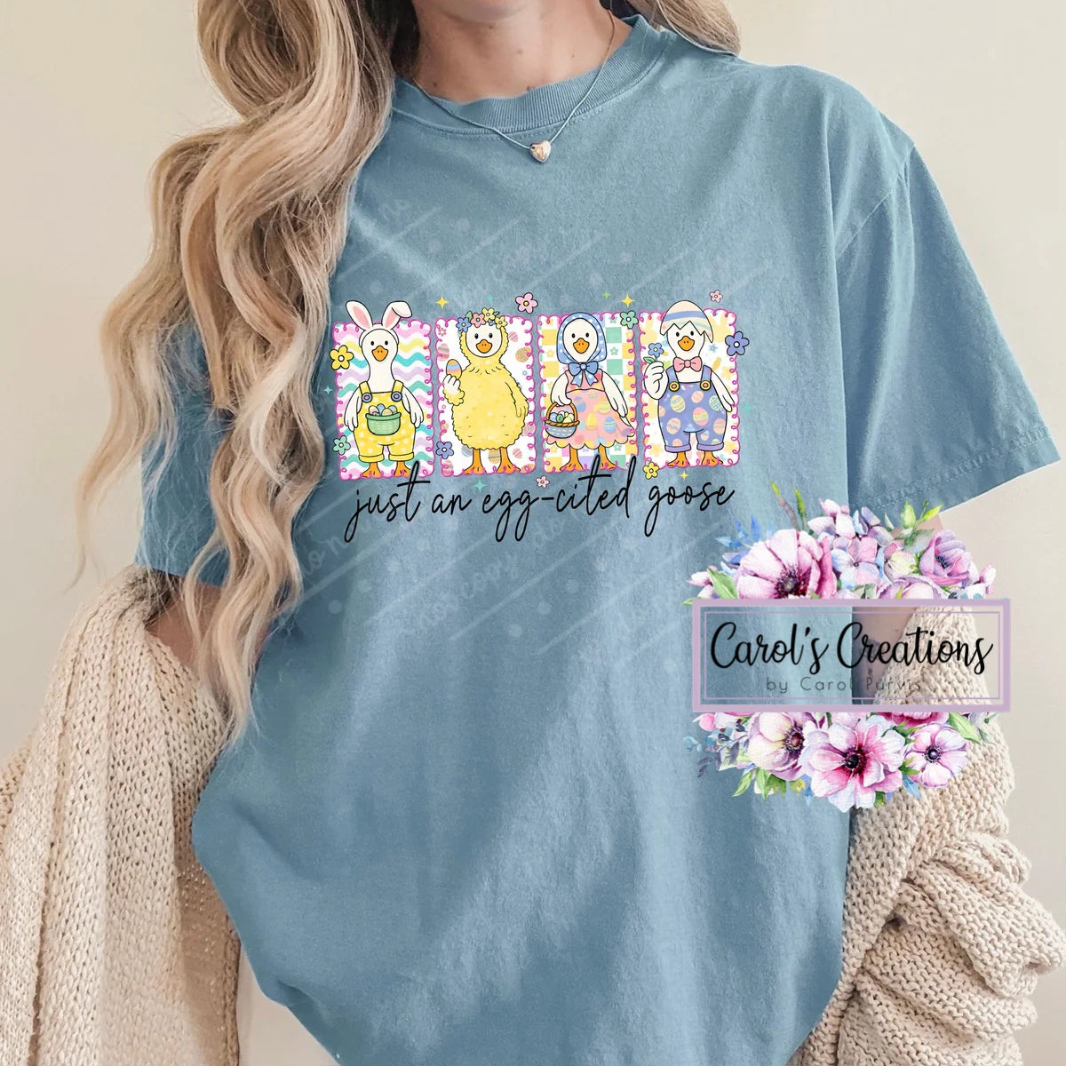 Person wearing a blue t-shirt with cartoon characters and text, with 'Carol's Creations' branding.