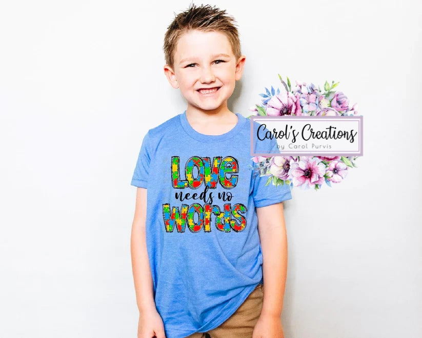 Child wearing a blue t-shirt with colorful text, standing against a white background with 'Carol's Creations' logo.