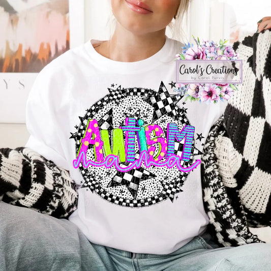 Person wearing a white sweatshirt with 'Autism Mama' design, sitting on a couch.