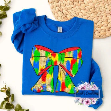 Blue sweatshirt with a colorful bow design on a white background