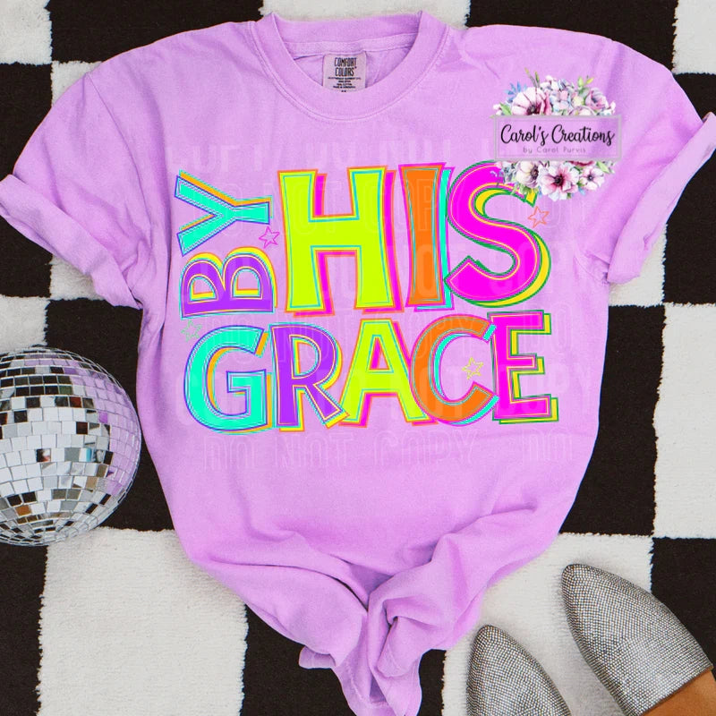 Purple t-shirt with 'BY HIS GRACE' text on a checkered background