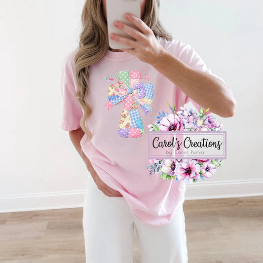 Person wearing a pink t-shirt with decorative elements and 'Carol's Creations' branding.