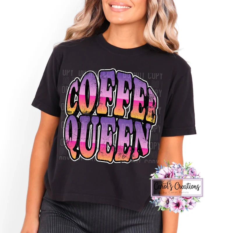 Person wearing a black t-shirt with 'Coffee Queen' in colorful letters on a white background.