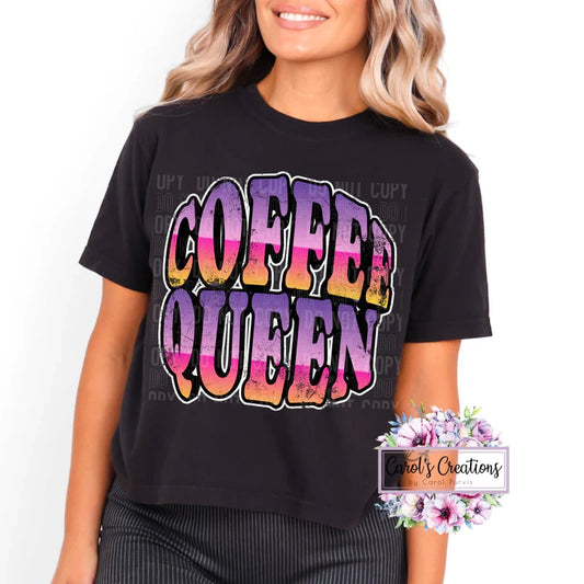 Person wearing a black t-shirt with 'Coffee Queen' in colorful letters on a white background.