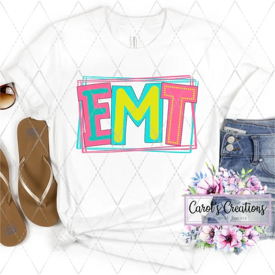 White t-shirt with colorful 'EMT' design, flip-flops, and jeans on a white background with floral watermark.