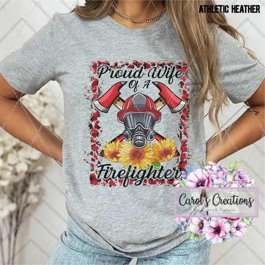 Gray t-shirt with a firefighter graphic and text, worn by a person.
