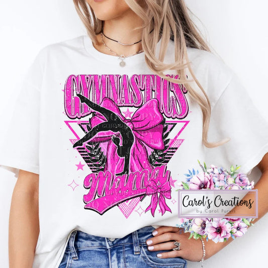 White t-shirt with pink and black 'Gymnastics Mommy' design, worn by a person.