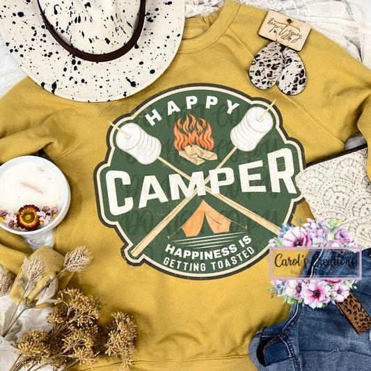 Yellow sweatshirt with 'Happy Camper' graphic and accessories on a white background