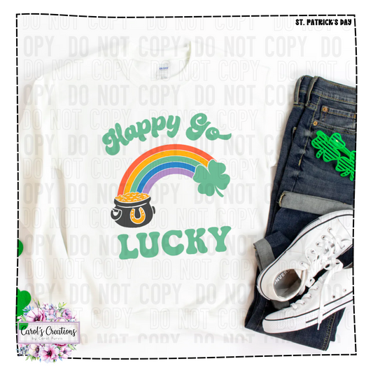 White sweatshirt with 'Happy Go Lucky' design featuring a rainbow and pot of gold, paired with jeans and sneakers.