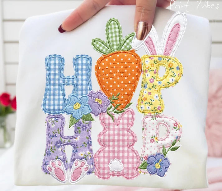 Embroidered design with colorful letters and Easter-themed elements on a white background.