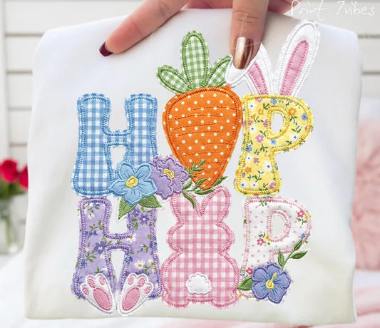 Embroidered design with colorful letters and Easter-themed elements on a white background.