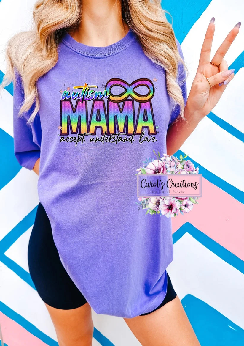 Person wearing a purple t-shirt with 'Rainbow Mama' text on a colorful geometric background
