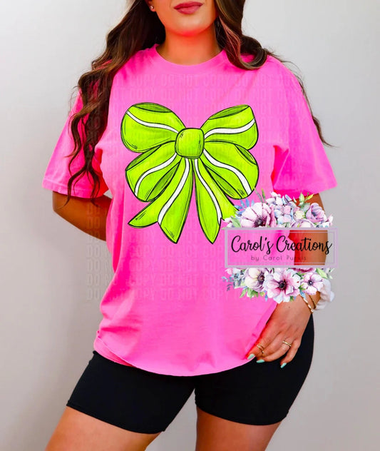 Person wearing a pink t-shirt with a green bow graphic, holding a bouquet of flowers.