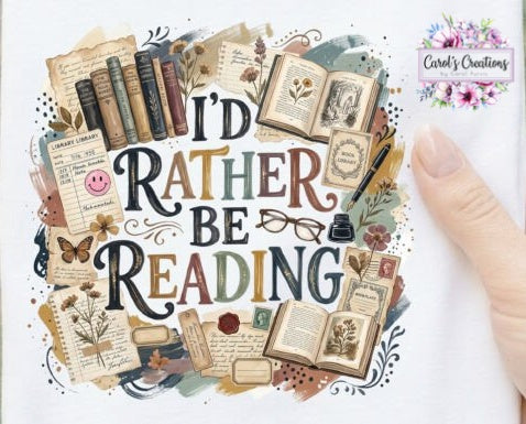 A close-up of a printed sign or book cover featuring the phrase “I’D RATHER BE READING” surrounded by illustrated vintage books, open books, notes, flowers, and a pair of glasses. A human finger is visible on the right side, touching the surface.