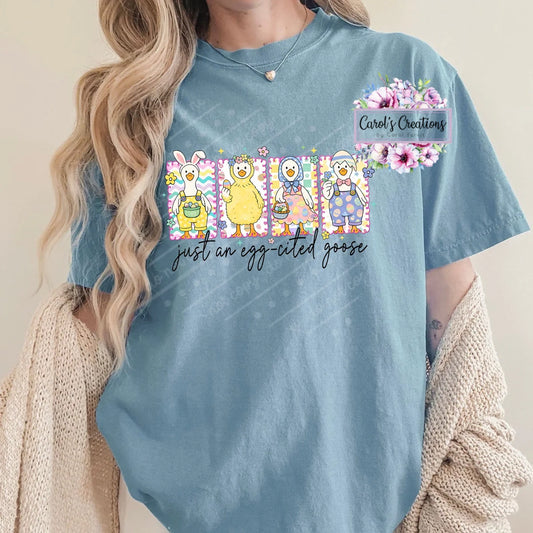 Person wearing a blue t-shirt with cartoon characters and text, against a neutral background