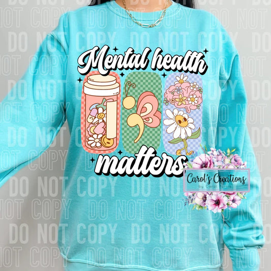 Light blue sweatshirt with 'Mental health matters' design and floral elements.
