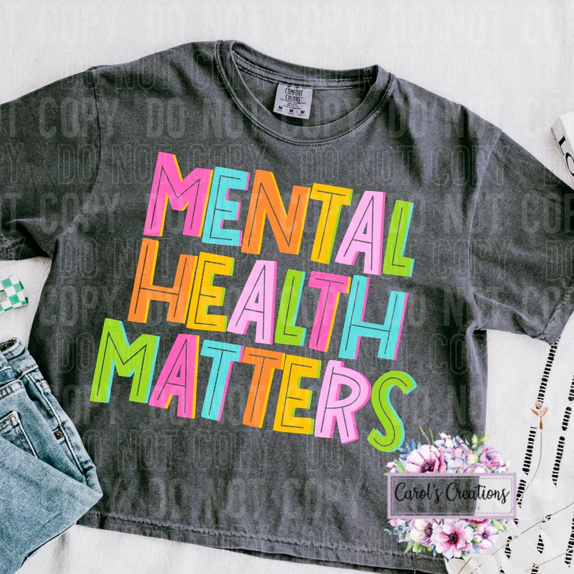 Gray t-shirt with 'Mental Health Matters' in colorful letters on a white background.