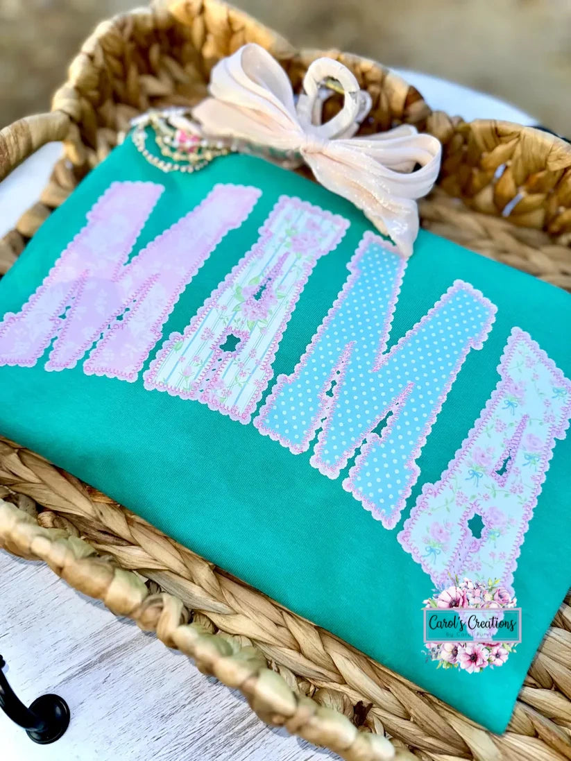 Beaded clutch with 'MOM' design on a textured surface