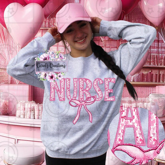Person wearing a gray sweatshirt with 'NURSE' in pink letters, standing in a pink-themed room with balloons.
