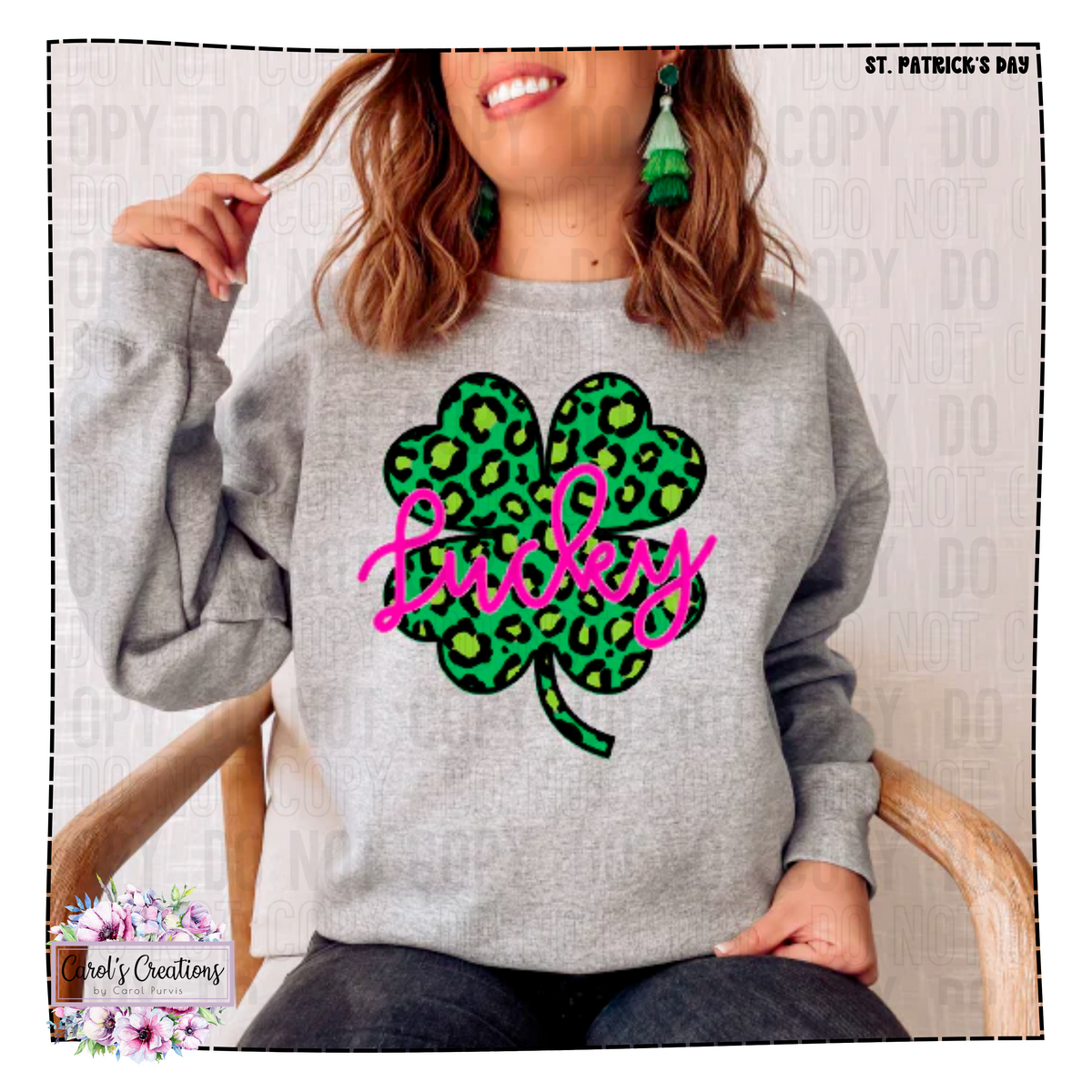 Person wearing a gray sweatshirt with a green shamrock and pink 'Lucky' text design.