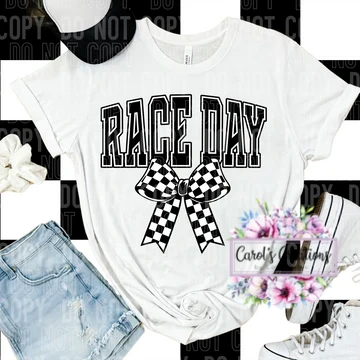 White t-shirt with 'Race Day' and bow design, paired with denim shorts and sneakers on a black and white striped background.