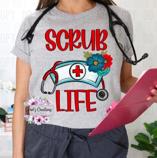 Person wearing a gray t-shirt with 'SCRUB LIFE' design, holding a pink folder.