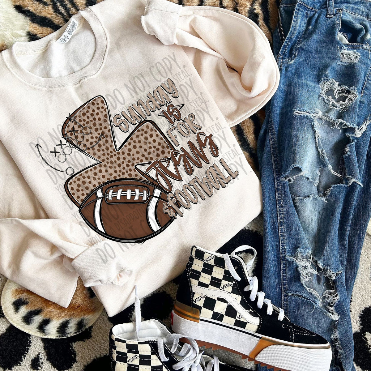 White sweatshirt with football graphic, jeans, and checkered sneakers on a patterned surface