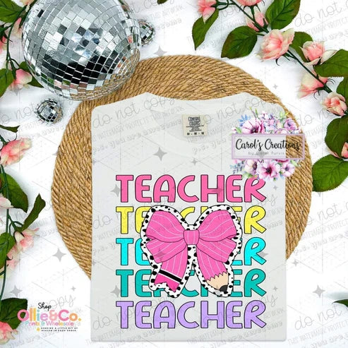 T-shirt with 'Teacher' text and pink bow design on a floral and disco ball background