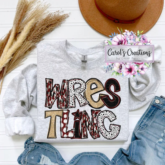 Gray sweatshirt with 'Wrestling' design, denim shorts, and a hat on a white surface.
