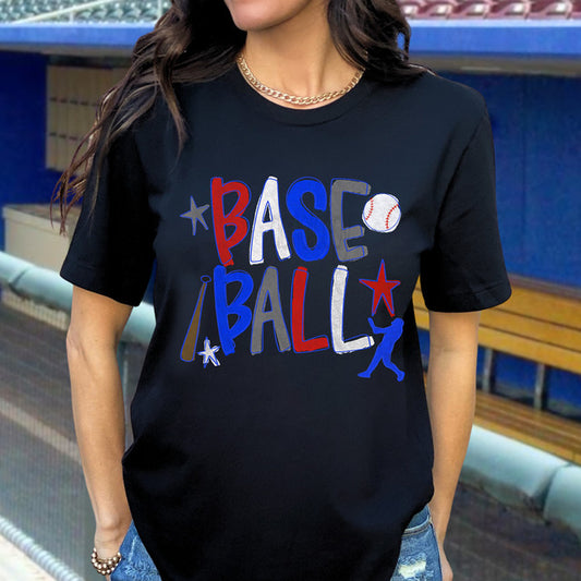 Person wearing a black t-shirt with colorful 'BASEBALL' text and graphics in a stadium setting.