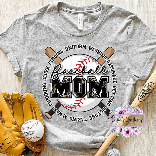 Gray t-shirt with 'Baseball Mom' graphic design on a wooden surface with baseball equipment.