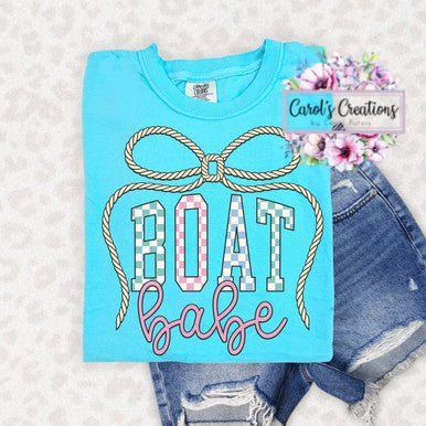 Blue t-shirt with 'BOAT babe' design and denim shorts on a light background