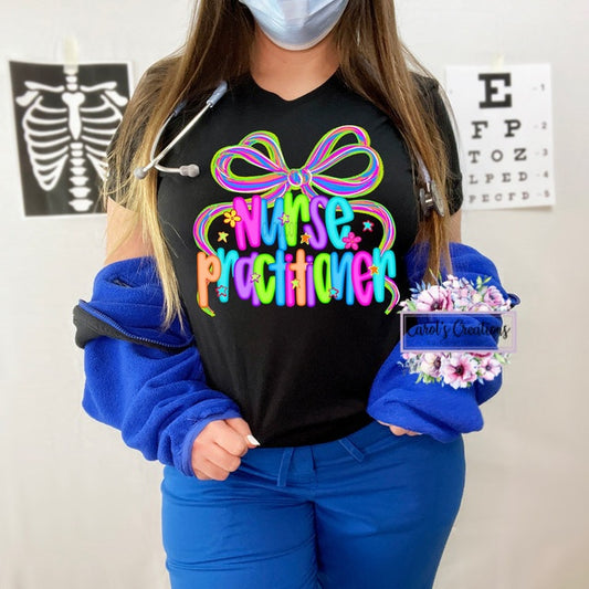 Person wearing a black shirt with colorful text and a blue jacket, holding a small box.