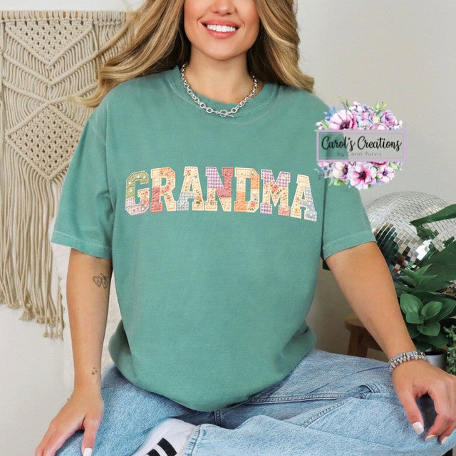 Person wearing a green t-shirt with 'GRANDMA' printed on it, sitting in a cozy room.