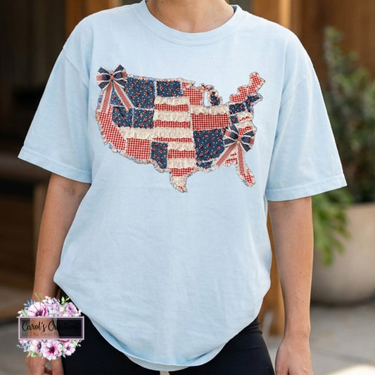 Light blue t-shirt with a U.S. map design featuring red, white, and blue patterns.