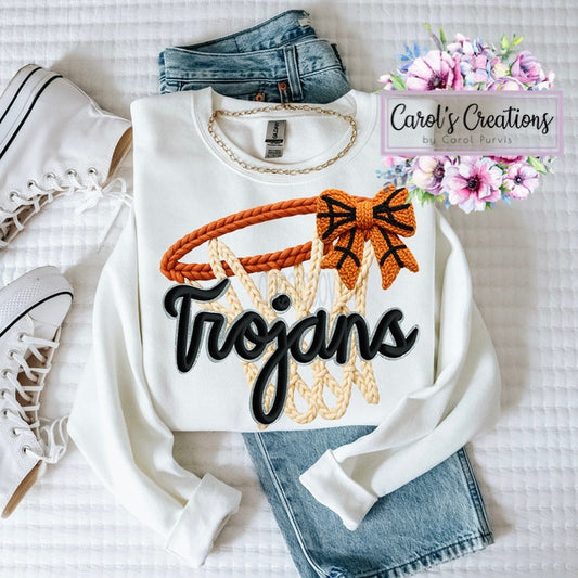White sweatshirt with 'Trojans' design, jeans, and sneakers on a white background with floral accents.