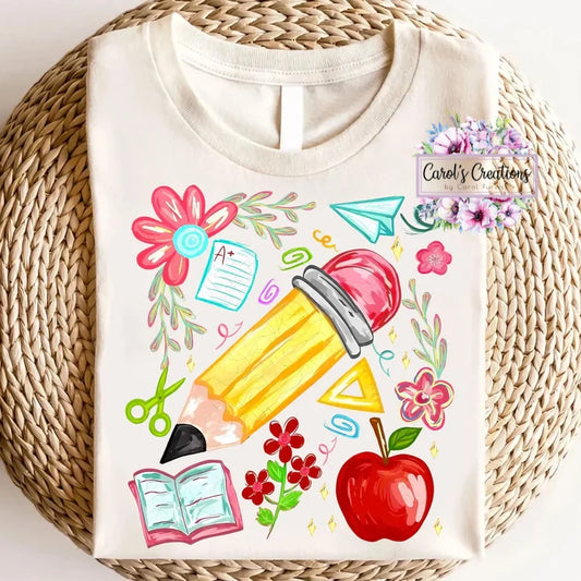 White t-shirt with colorful school-themed design on a woven surface