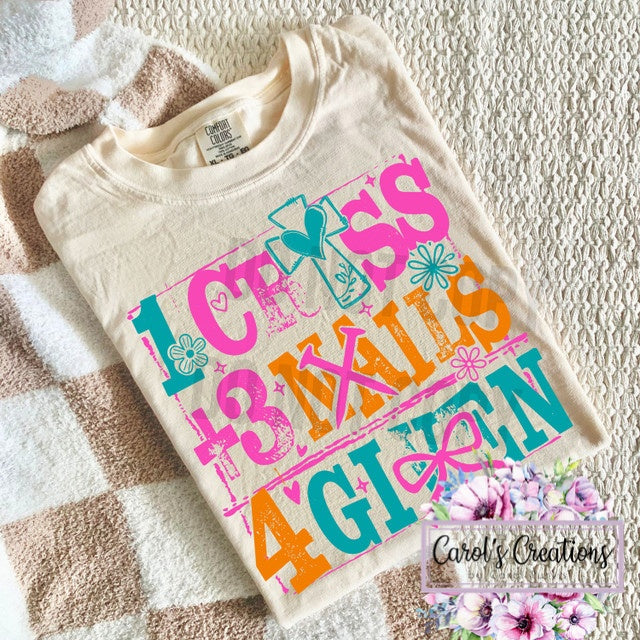 Beige t-shirt with colorful text design on a textured surface