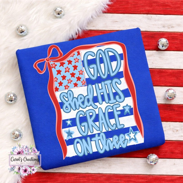 Blue pillow with patriotic text design on a wooden surface.
