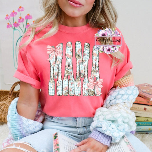 Person wearing a pink t-shirt with floral 'MAMA' design, sitting on a couch with books and a basket in the background.