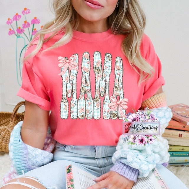 Person wearing a pink t-shirt with floral 'MAMA' design, holding a product with 'Carolee Creations' branding.