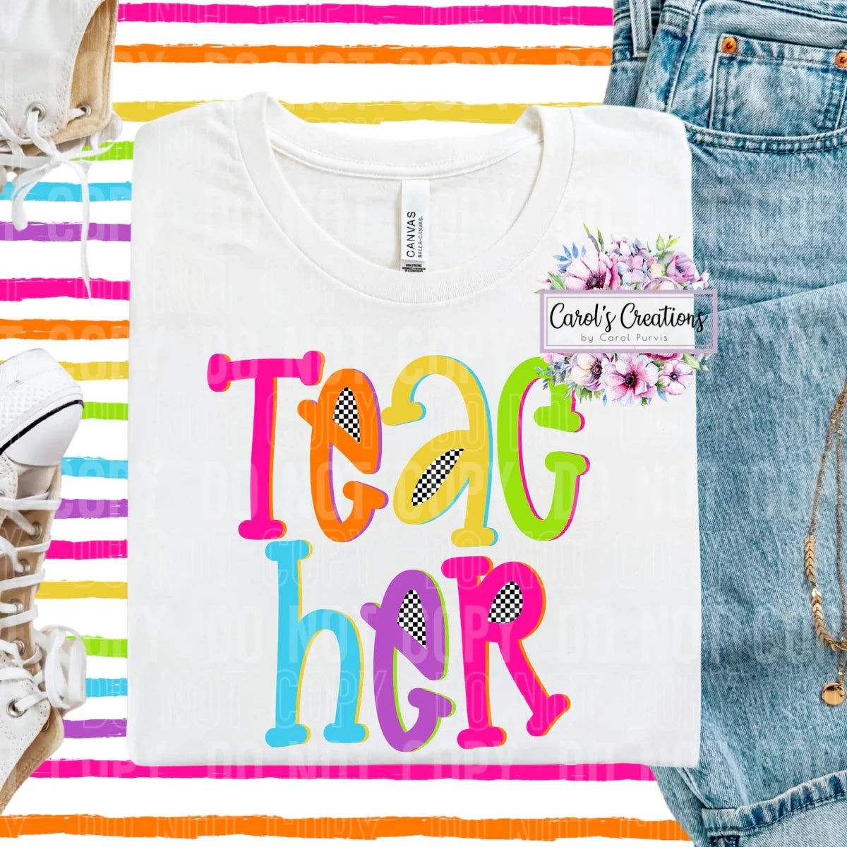 White t-shirt with colorful 'TEACH HER' text, denim jeans, and rainbow stripes in the background.