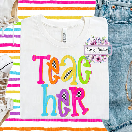 White t-shirt with colorful 'TEACH HER' text, denim jeans, and rainbow stripes in the background.