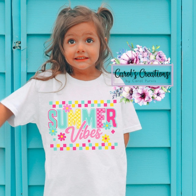 Child wearing a 'Summer Vibes' t-shirt with floral decorations in the background