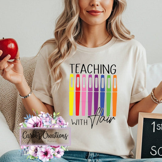 Person wearing a 'Teaching with Flair' t-shirt holding an apple, surrounded by decorative elements.