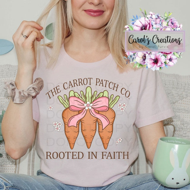Person wearing a t-shirt with 'The Carrot Patch Co. Do You Rooted in Faith' design, sitting next to a mug with a rabbit design.